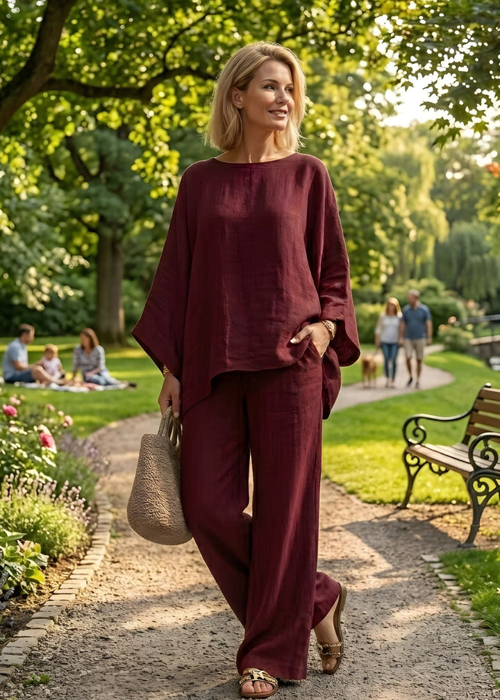 Vacation-ready women's two-piece set featuring a chic cape top & flowy wide-leg pants. Ideal resort wear.