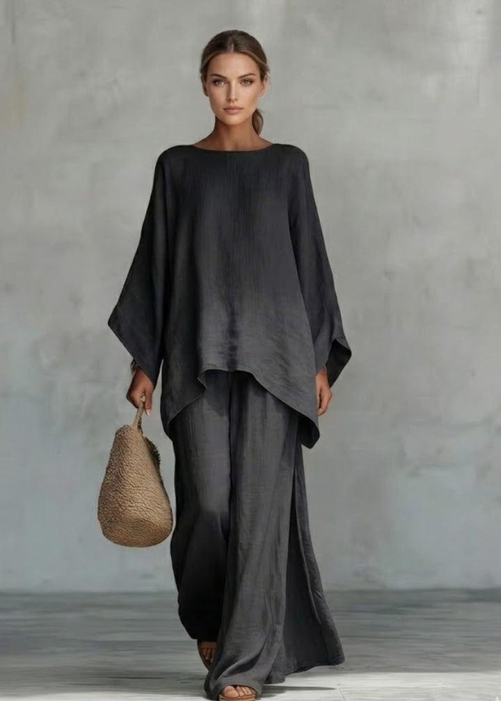Elegant women's two-piece ensemble: stylish cape top & wide-leg pants for a sophisticated bohemian chic look.