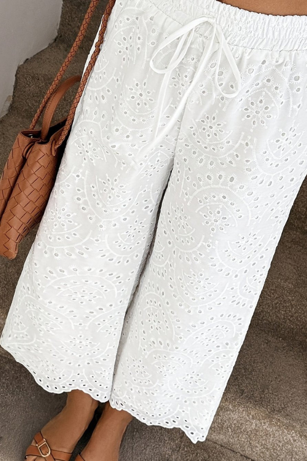 Lightweight women's cropped bohemian pants with eyelet accents. Relaxed fit, perfect for summer vacation & beach style.