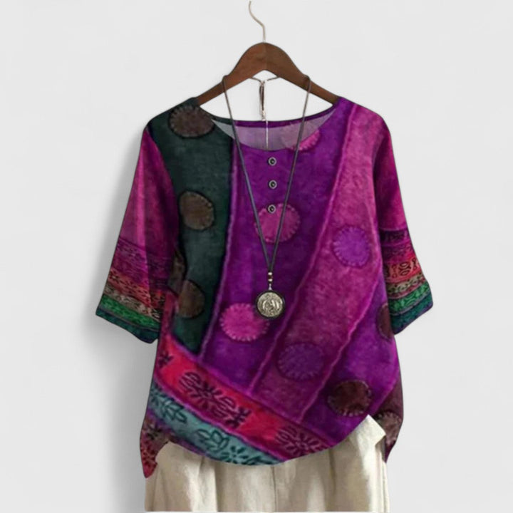 Close-up of a women's bohemian patchwork top, showcasing the vibrant printed fabric and short sleeves.