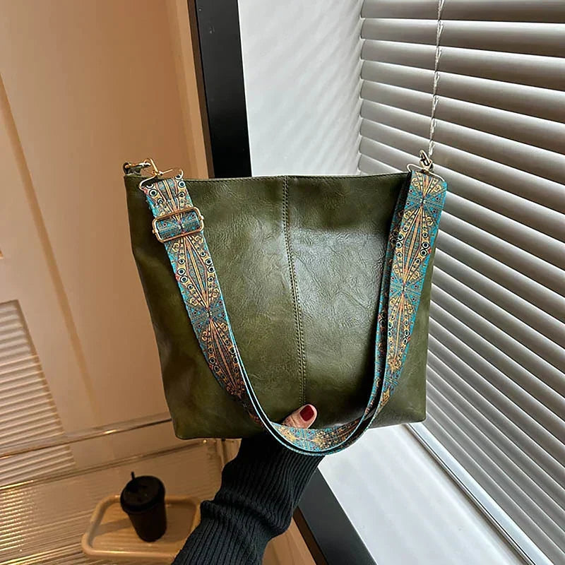 Women's bohemian shoulder bag, faux leather, with a richly detailed, patterned textile strap.