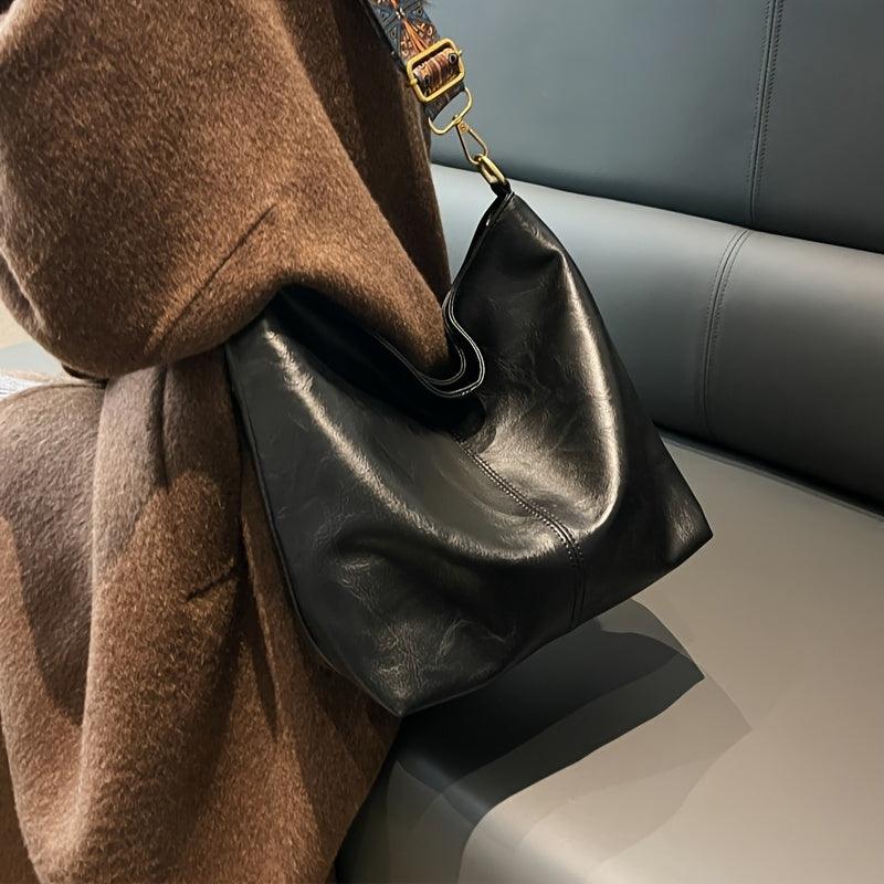 Bohemian women's shoulder bag with a distinct patterned strap. Faux leather slouchy style.