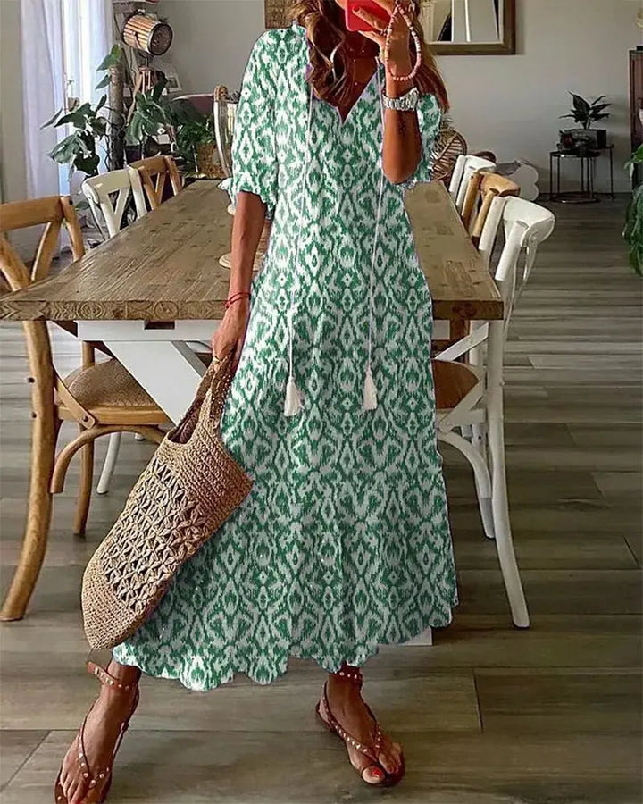 Flowy summer boho midi dress for women featuring elegant lantern sleeves & vibrant geometric print; perfect vacation style.