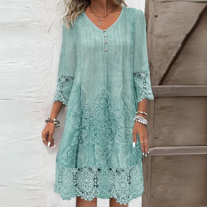 Relaxed fit women's boho midi dress featuring intricate embroidery and feminine lace trim detail.