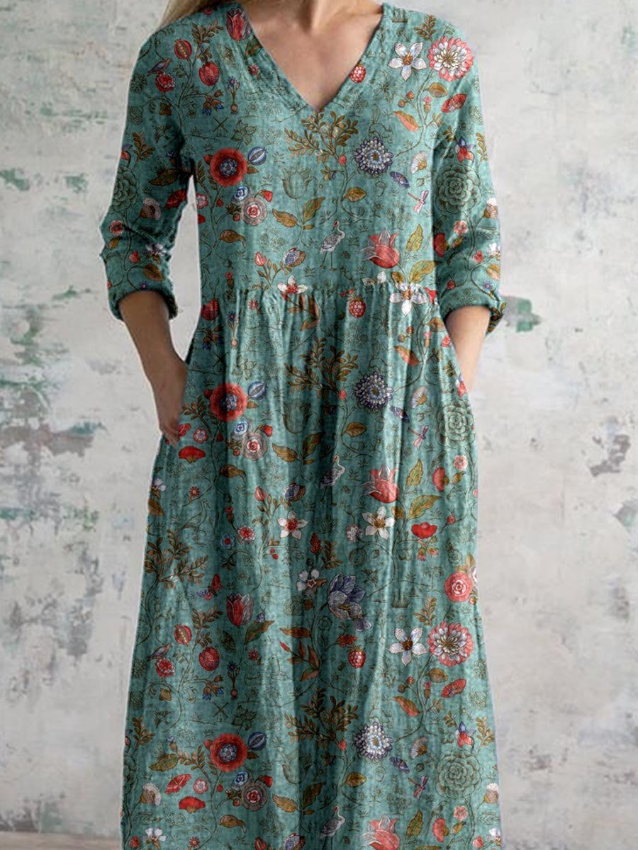 Flowy women's boho maxi dress, featuring a vibrant floral print, flattering V-neck, and practical three-quarter sleeves.