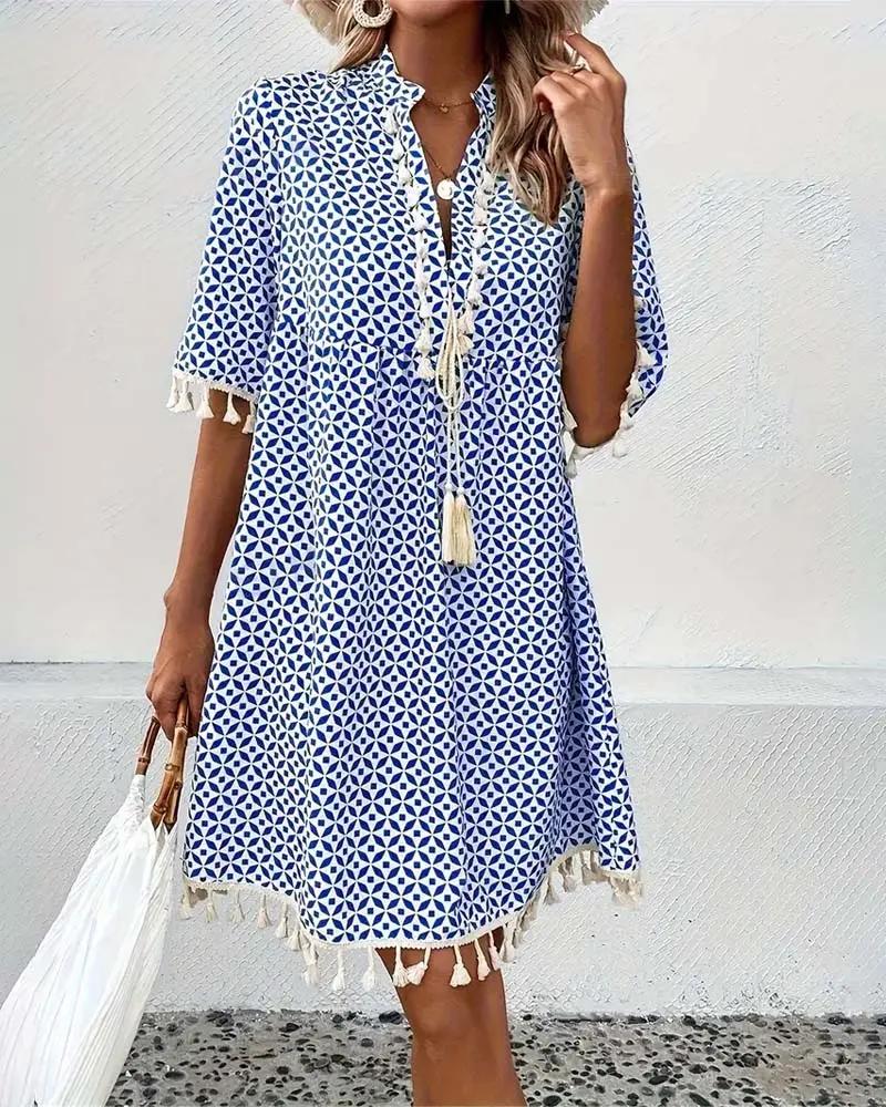Flowy women's mini boho tunic dress, featuring a unique geometric print and stylish tassel details for summer.