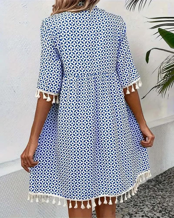 Boho mini tunic dress for women, vibrant geometric print, short sleeves & tassel hem. Great summer beach wear.