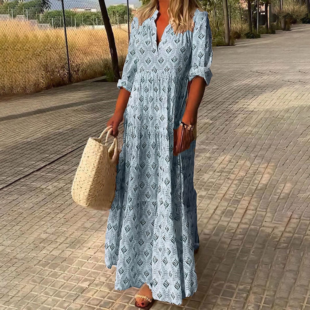 Flowy bohemian maxi dress for women, ideal for spring/summer vacation. Features a relaxed fit and long roll-up sleeves.