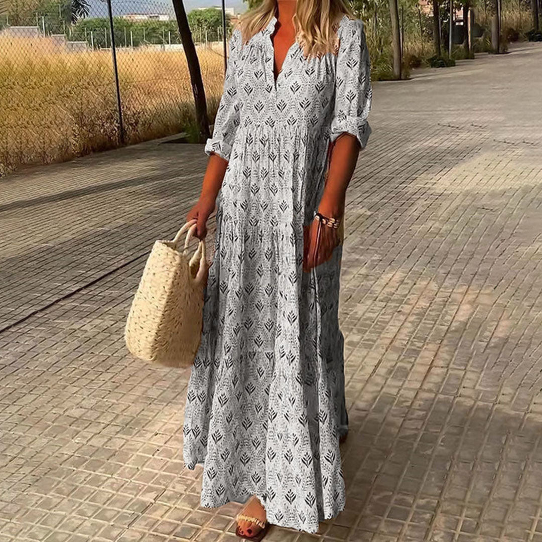 Elegant women's maxi dress with a vibrant boho print, V-neck, and versatile roll-up sleeves. Great for everyday or travel.