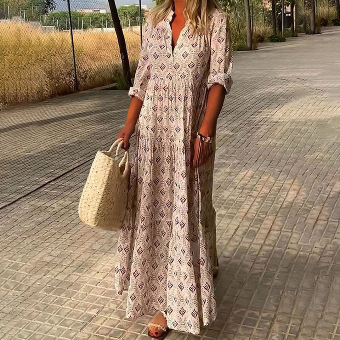 Chic women's spring/summer maxi dress, featuring a boho print, V-neck, and roll-up sleeves. Versatile for casual or elegant.