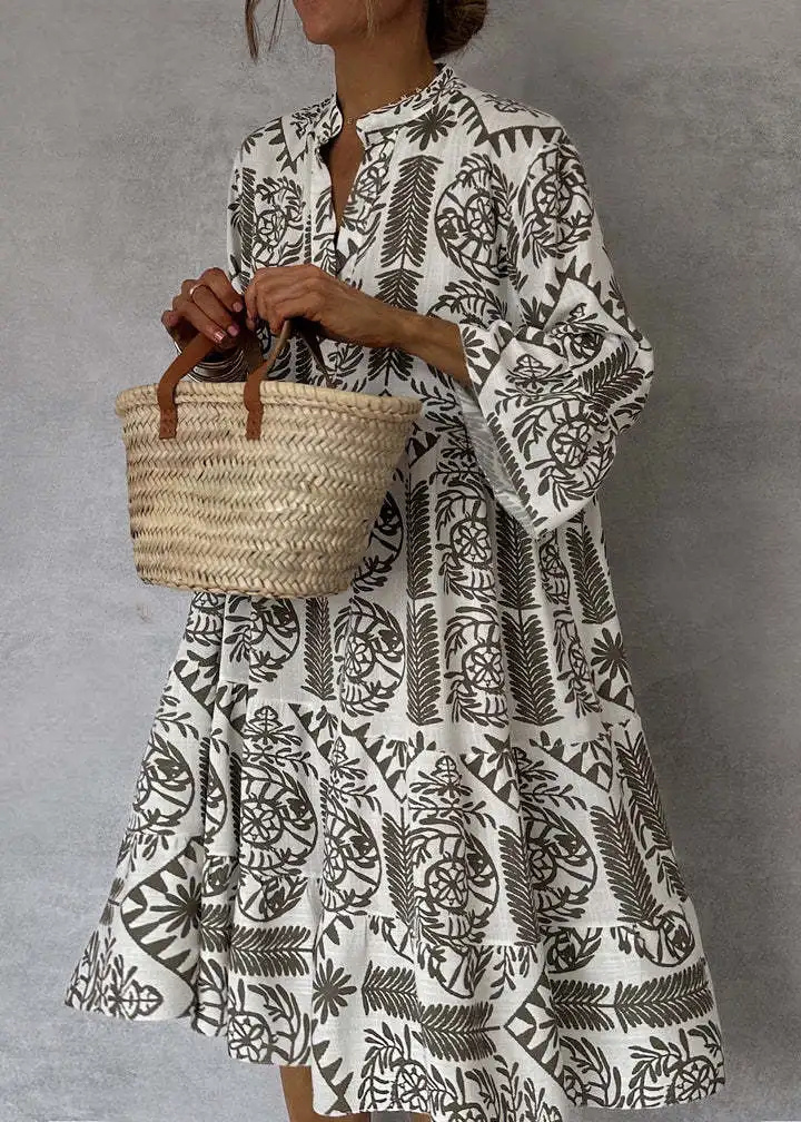 Vibrant boho print midi dress for women. Oversized, flowy silhouette with long sleeves. Ideal for casual wear.