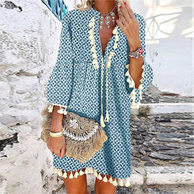 Women's boho V-neck mini dress with playful tassels, bell sleeves & loose fit. Ideal for casual summer/spring fashion.