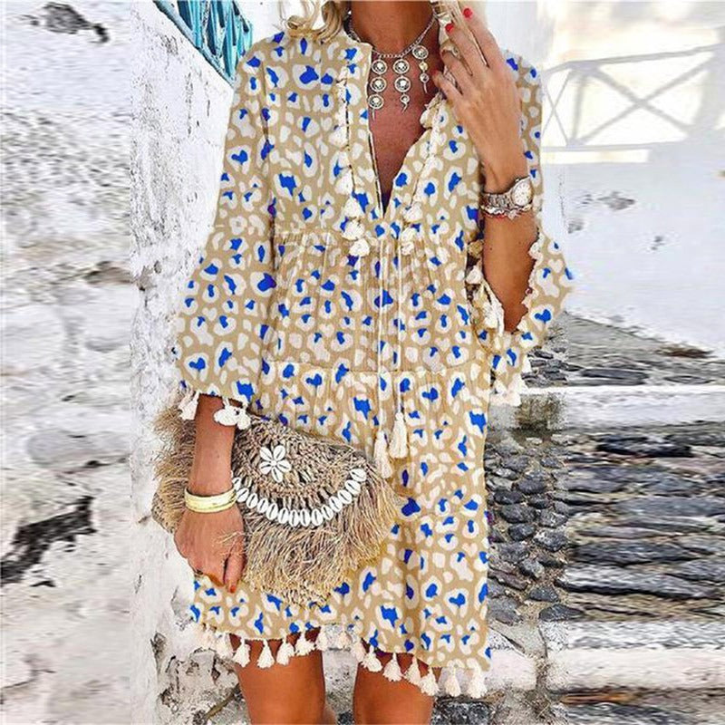 Chic bohemian women's V-neck mini dress. Features tassels, bell sleeves & loose fit for casual spring/summer style.