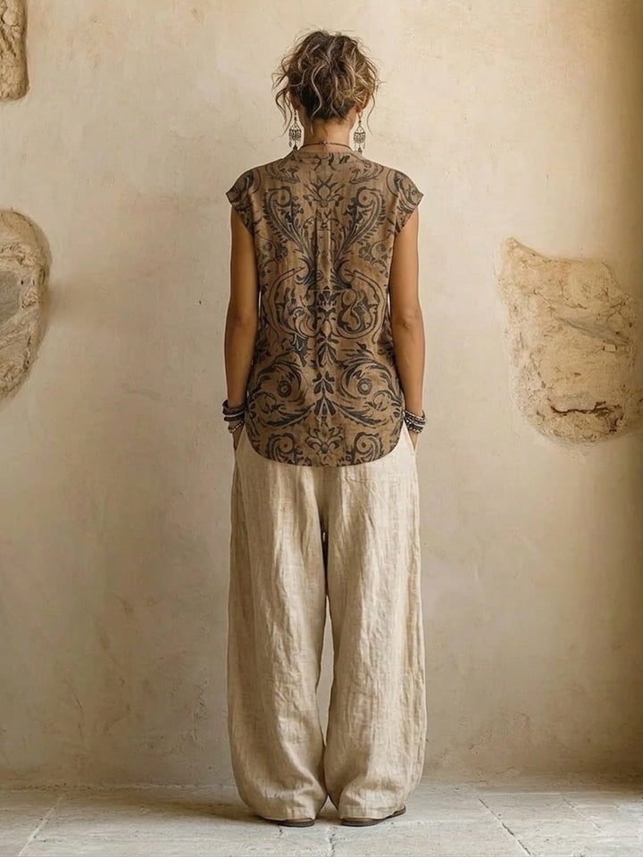 Stylish three-piece women's outfit: comfortable wide leg pants, top, & ethnic boho print cardigan for summer fashion.