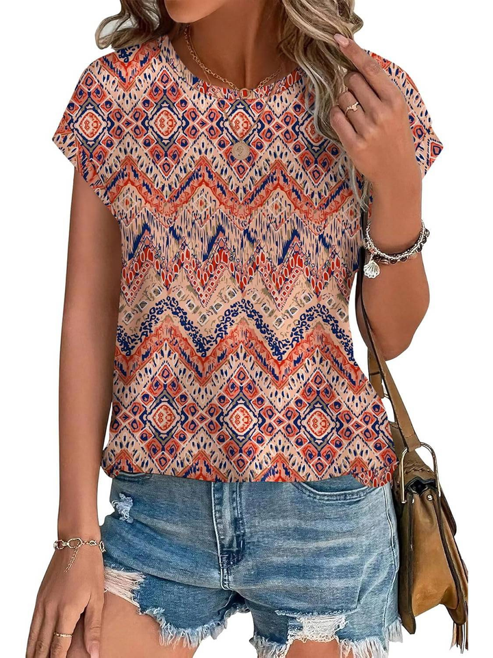 Close-up view of the women's vibrant botanical leaf print on a comfortable cap sleeve blouse.
