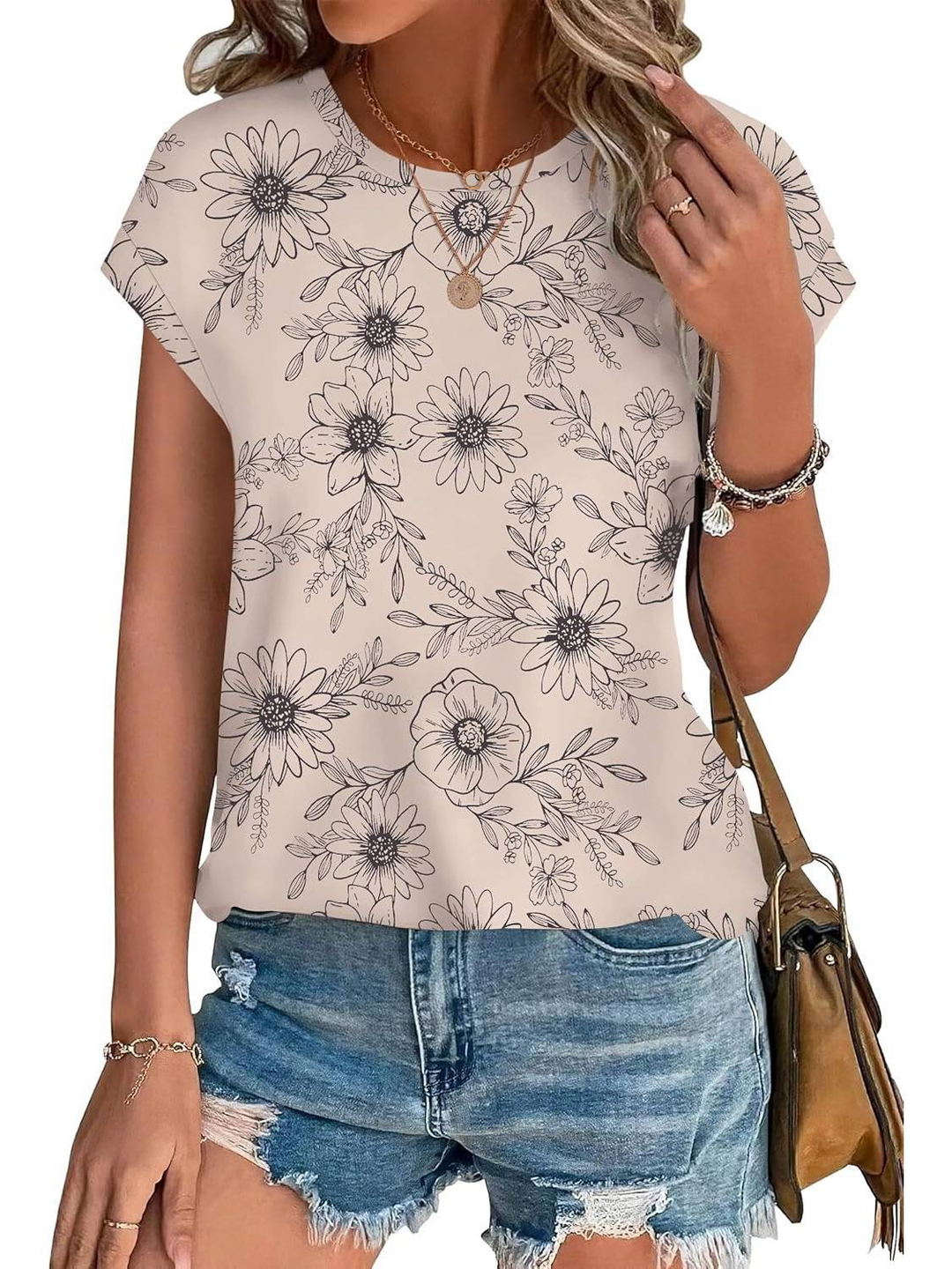 Chic women's cap sleeve top with a vibrant botanical leaf pattern, offering refreshing summer style.
