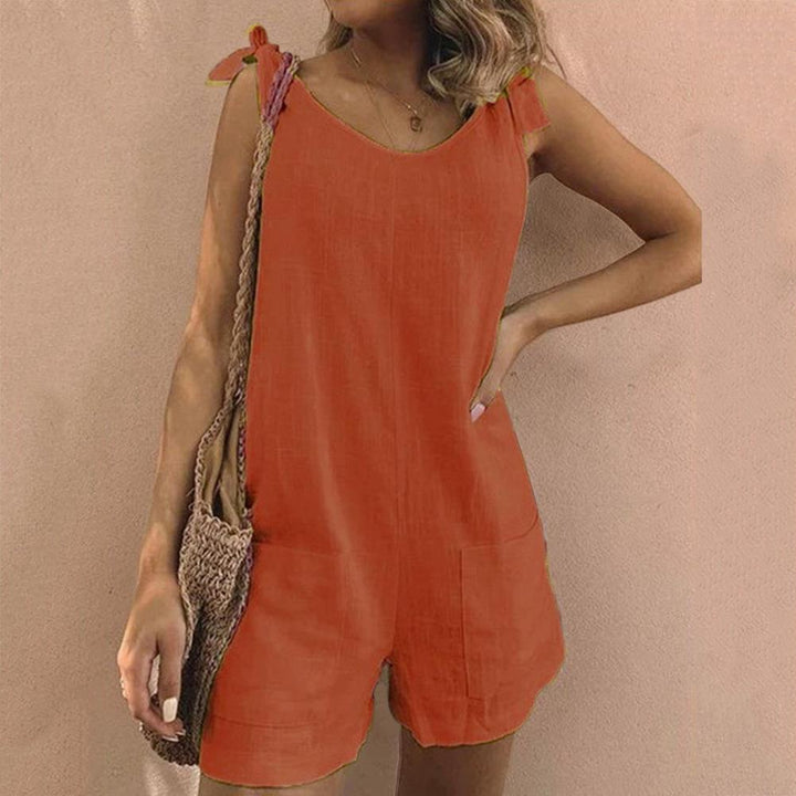 Stylish women's romper with adjustable bow straps and functional pockets, ideal for warm weather fashion.