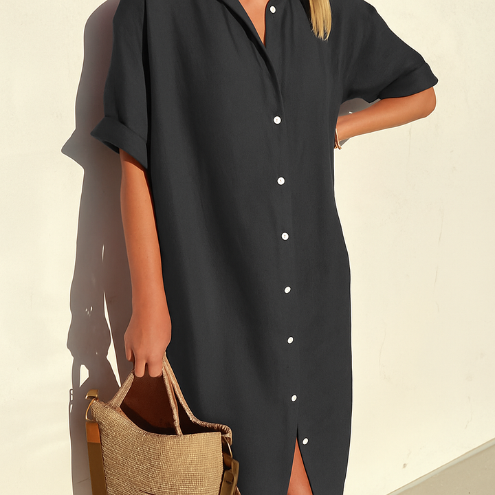 Close-up of elegant buttons and breathable fabric on a women's breezy button-down midi shirt dress.