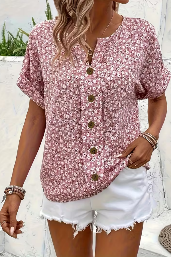 Close-up of a women's floral blouse, highlighting the vibrant print & breezy fabric for summer.