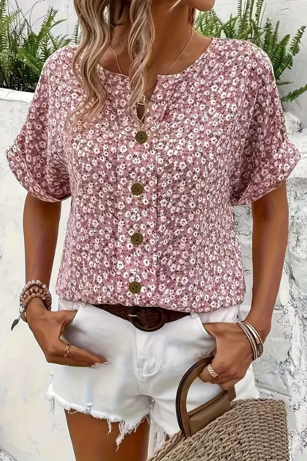 Stylish woman wearing a relaxed fit floral short sleeve blouse, ideal as a casual vacation outfit.