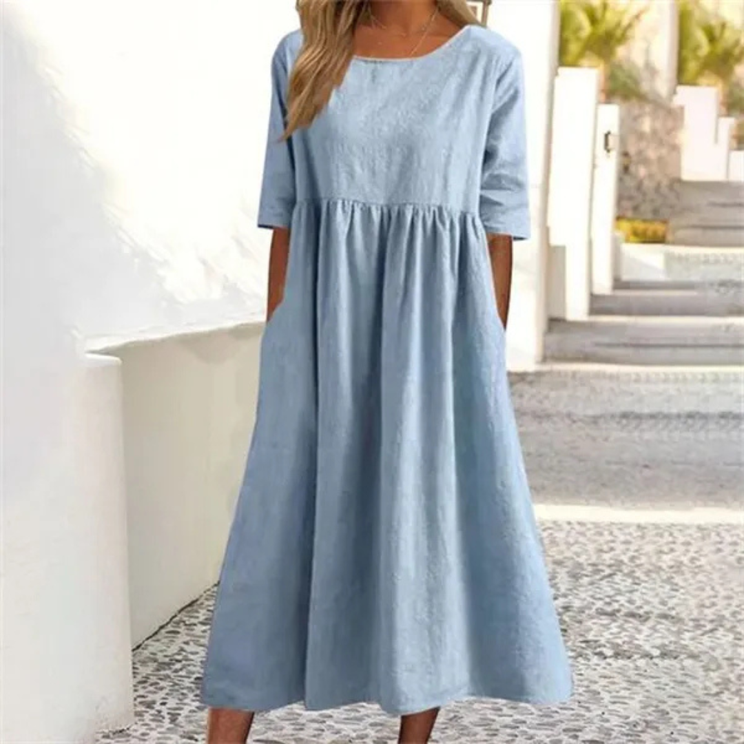 Women's breezy smocked-waist summer midi dress with short sleeves & pockets for casual wear.