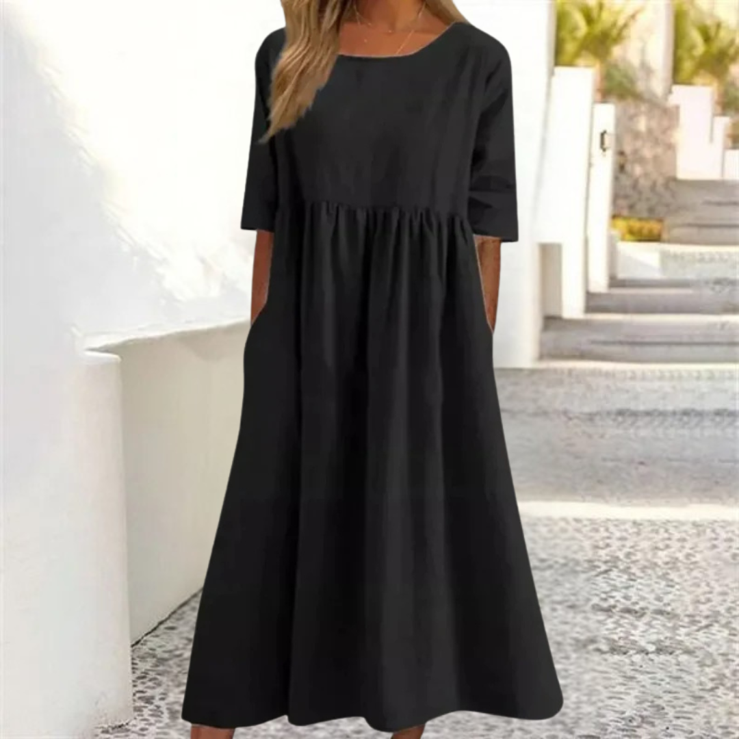 Elegant A-line women's summer midi dress featuring a smocked waist & short sleeves for vacation.
