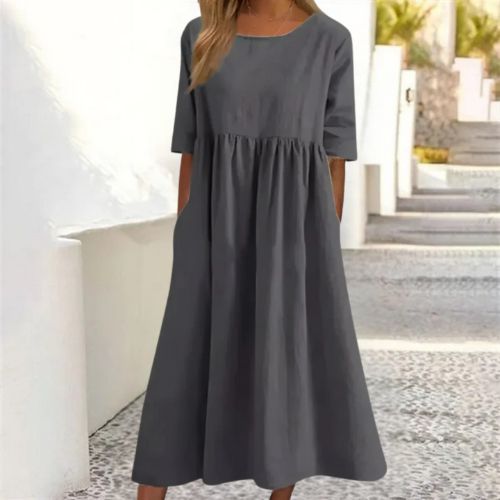 Vacation-ready women's breezy smocked-waist midi dress with short sleeves. A comfy summer casual dress.