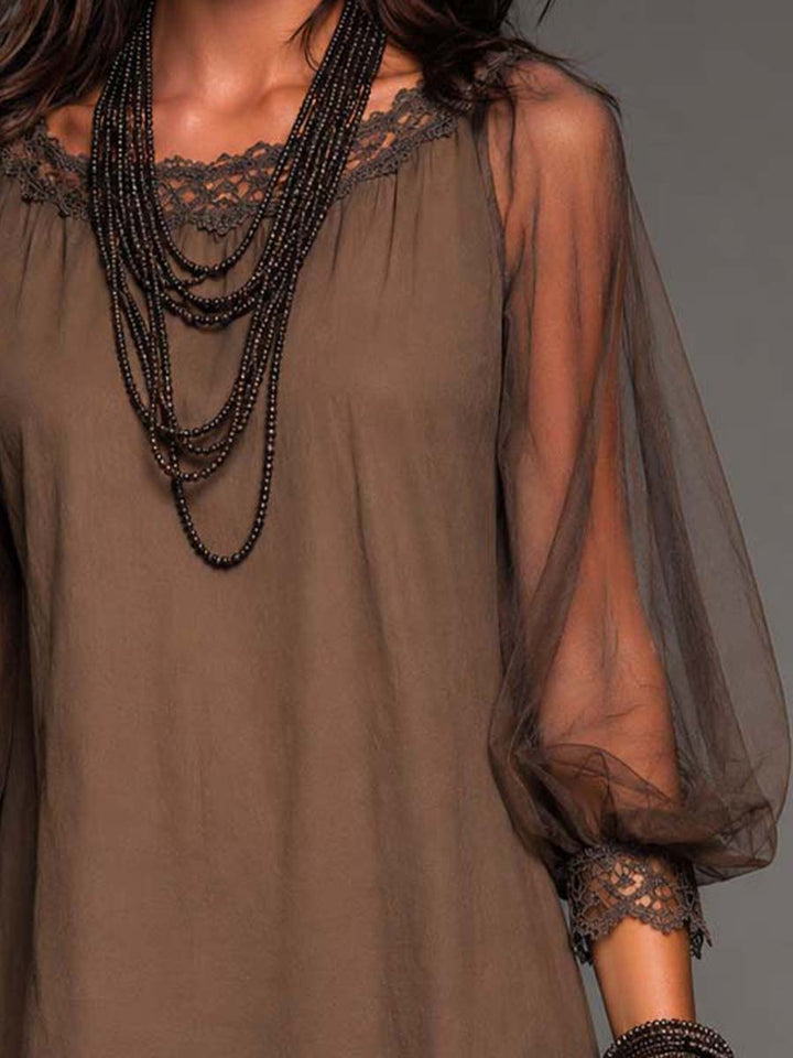 Flowy brown floral boho mini dress for women. Features sheer long sleeves, round neck, and elegant crochet hem.