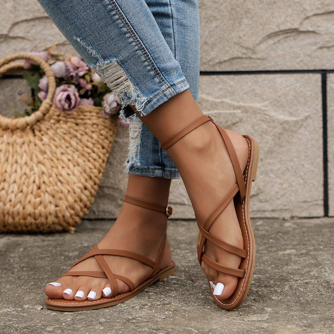 Versatile women's flat sandals with open-toe design & ankle strap. Perfect comfortable footwear for summer.
