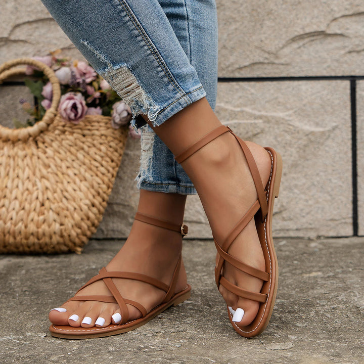 Versatile women's flat sandals with open-toe design & ankle strap. Perfect comfortable footwear for summer.