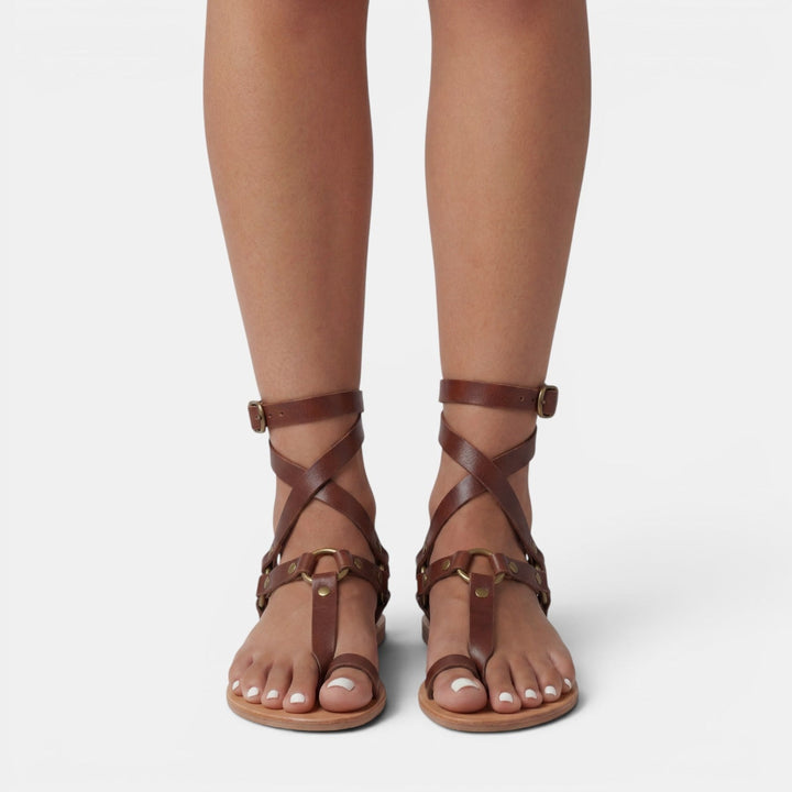 Trendy women's snake print flat sandals, buckled crossover design, perfect for summer casual wear.
