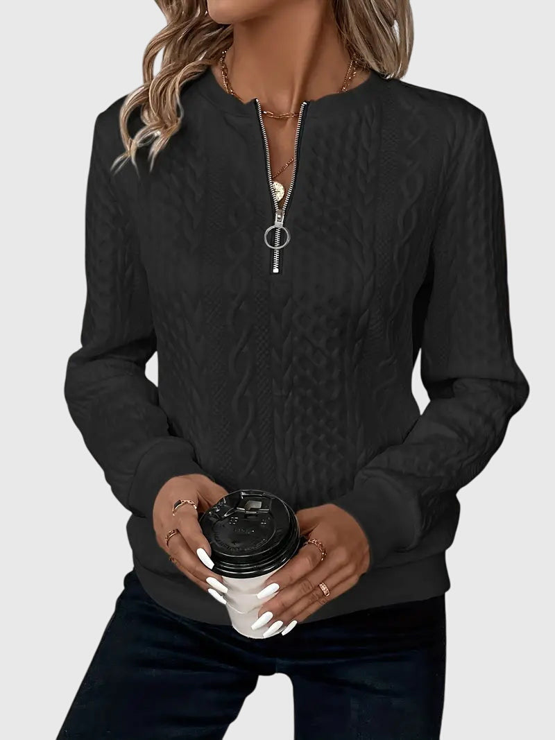 Warm women's cable knit quarter-zip sweater, a comfortable pullover for chilly days.