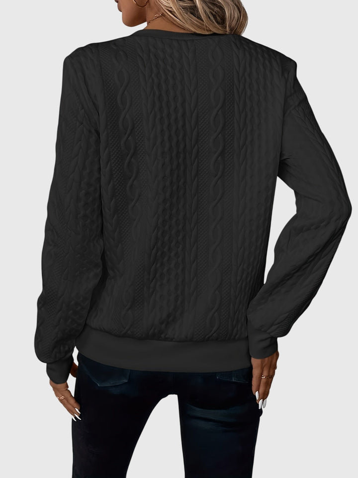 Textured women's cable knit quarter-zip pullover, a stylish and versatile top for fall.