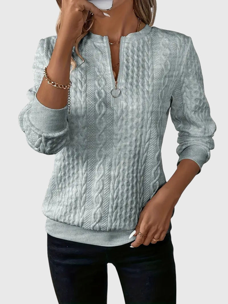 Women's cable knit quarter-zip sweater, a chic and modern fit for your winter wardrobe.