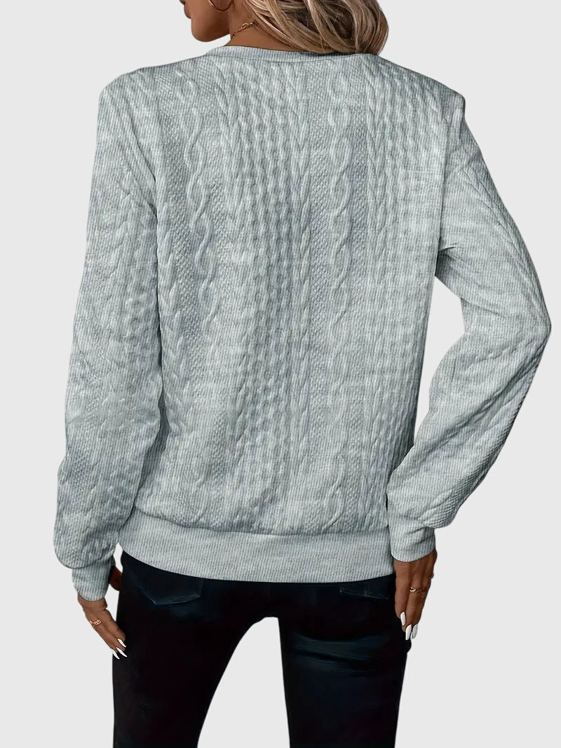 Stylish women's cable knit quarter-zip sweater, featuring a beautiful textured design.