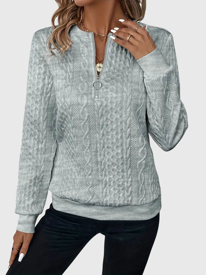 Women's cable knit quarter-zip sweater, a comfortable and chic option for casual outings.