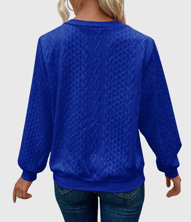 Chic women's cable knit quarter-zip pullover, perfect for layering and everyday wear.
