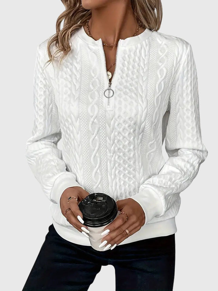 Effortless women's cable knit quarter-zip sweater, a cozy layering piece for casual outfits.