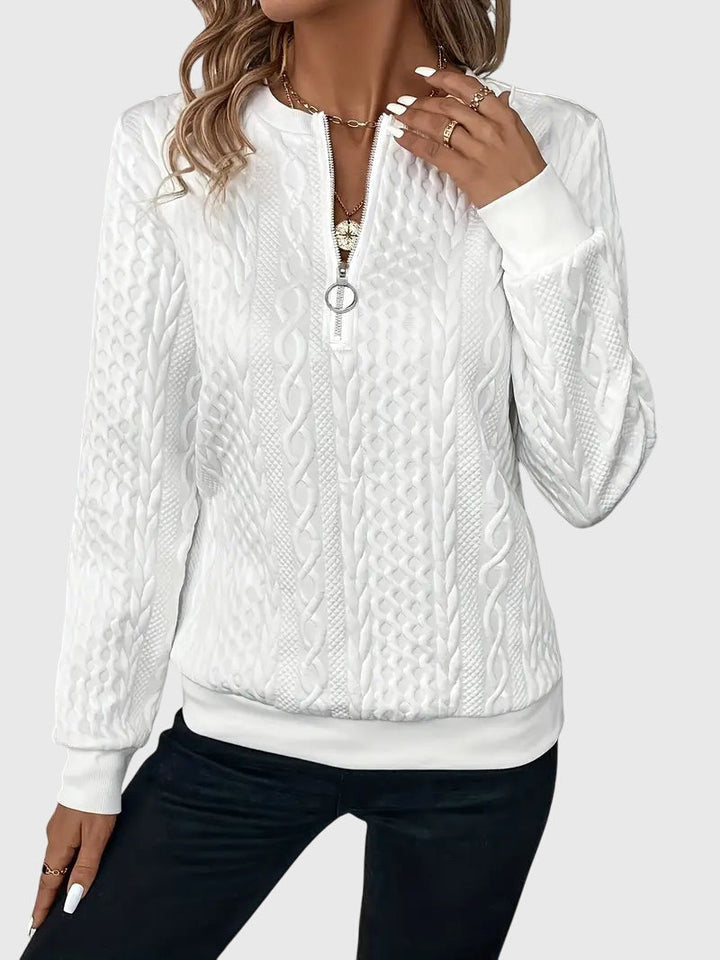 Stylish women's quarter-zip cable knit sweater, a textured pullover for winter fashion.