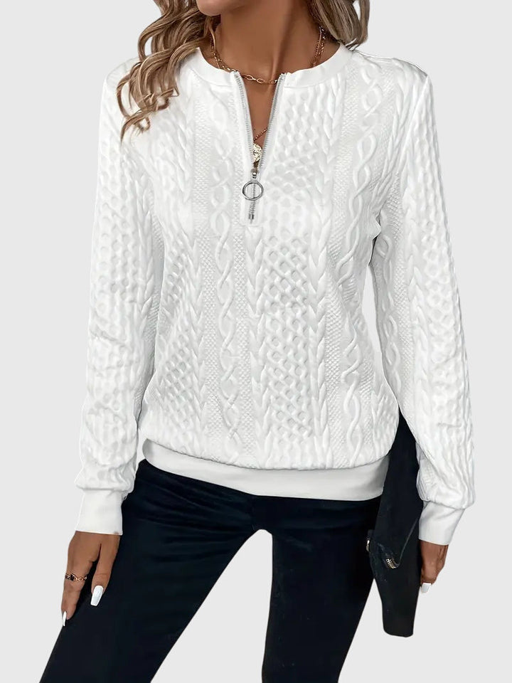 Women's cable knit quarter-zip sweater, an essential everyday style piece for warmth.