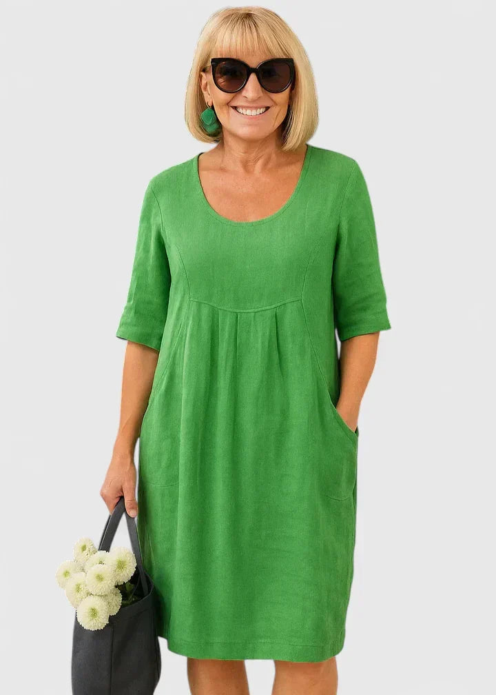 Women's casual A-line summer midi dress with pockets, scoop neck, and half sleeves for comfortable everyday wear.