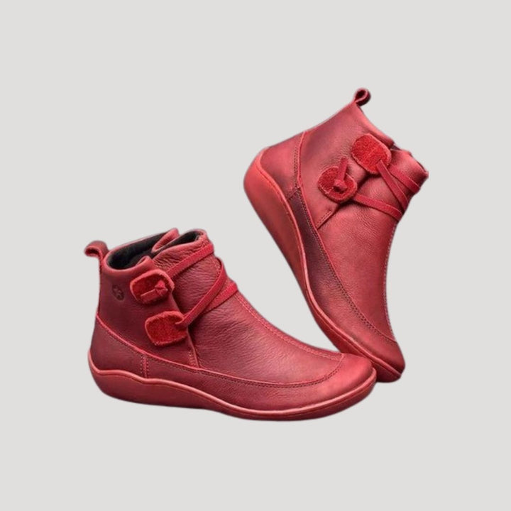 Close-up of a women's casual ankle boot featuring decorative straps and a comfortable low heel for spring.