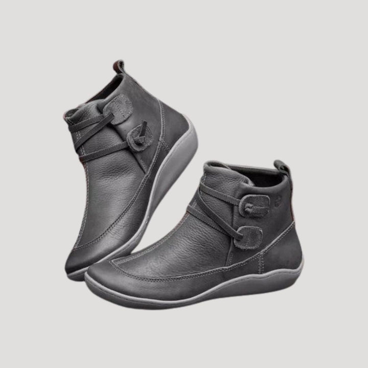 Stylish women's spring ankle boots, black with silver buckle accents, ideal for casual and fashion-forward looks.