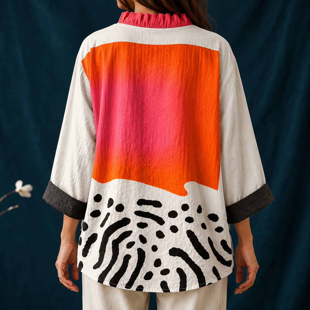 Stylish women's button-up blouse with an abstract block pattern, long sleeves, and a chic ruffled collar for casual style.