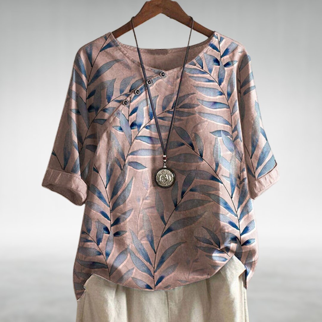 Relaxed fit women's button-up shirt with a stylish leaf print, ideal for spring tops