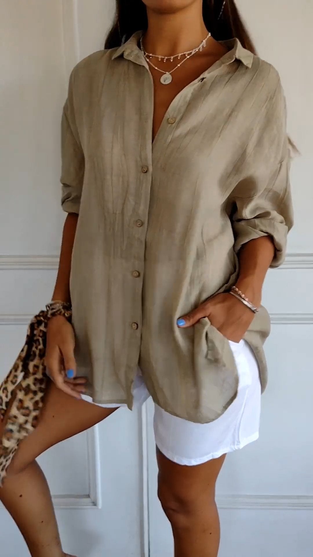 Chic oversized button-down blouse for women, ideal as a versatile spring top or summer cover-up.