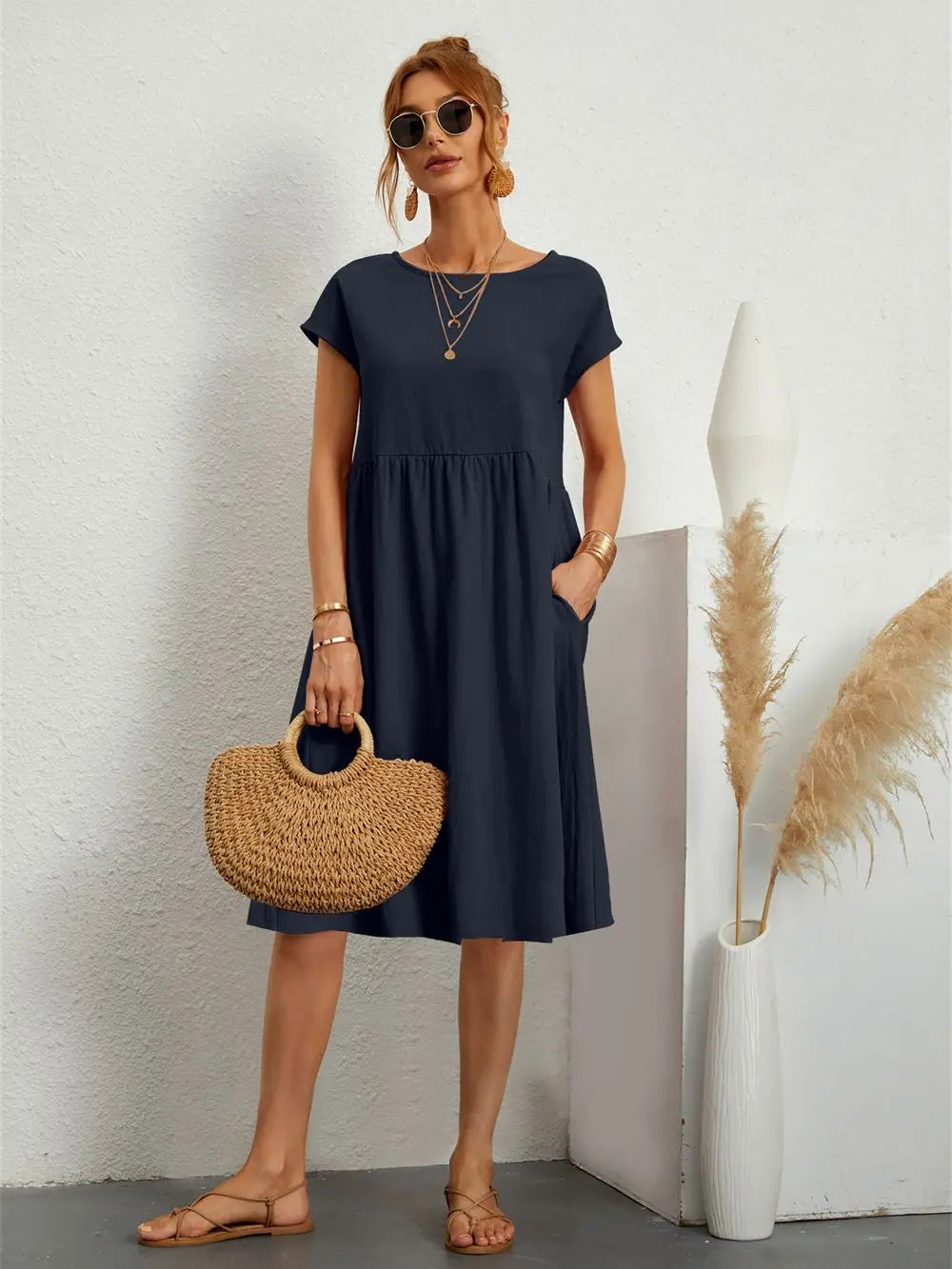 Women's casual midi dress with pockets. Comfortable, loose fit, short sleeve for spring/summer wear.