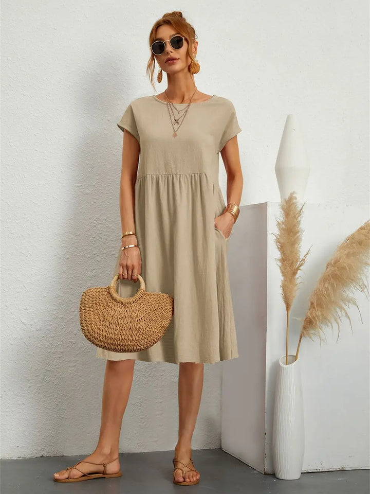 Stylish women's midi dress with convenient pockets. Casual short sleeve design, perfect for daily wear.