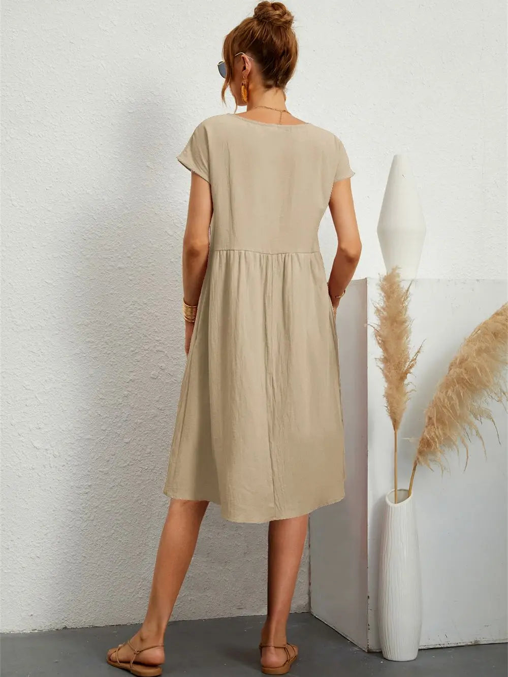 Effortless spring/summer midi dress for women. Casual, loose-fit with short sleeves & practical pockets.