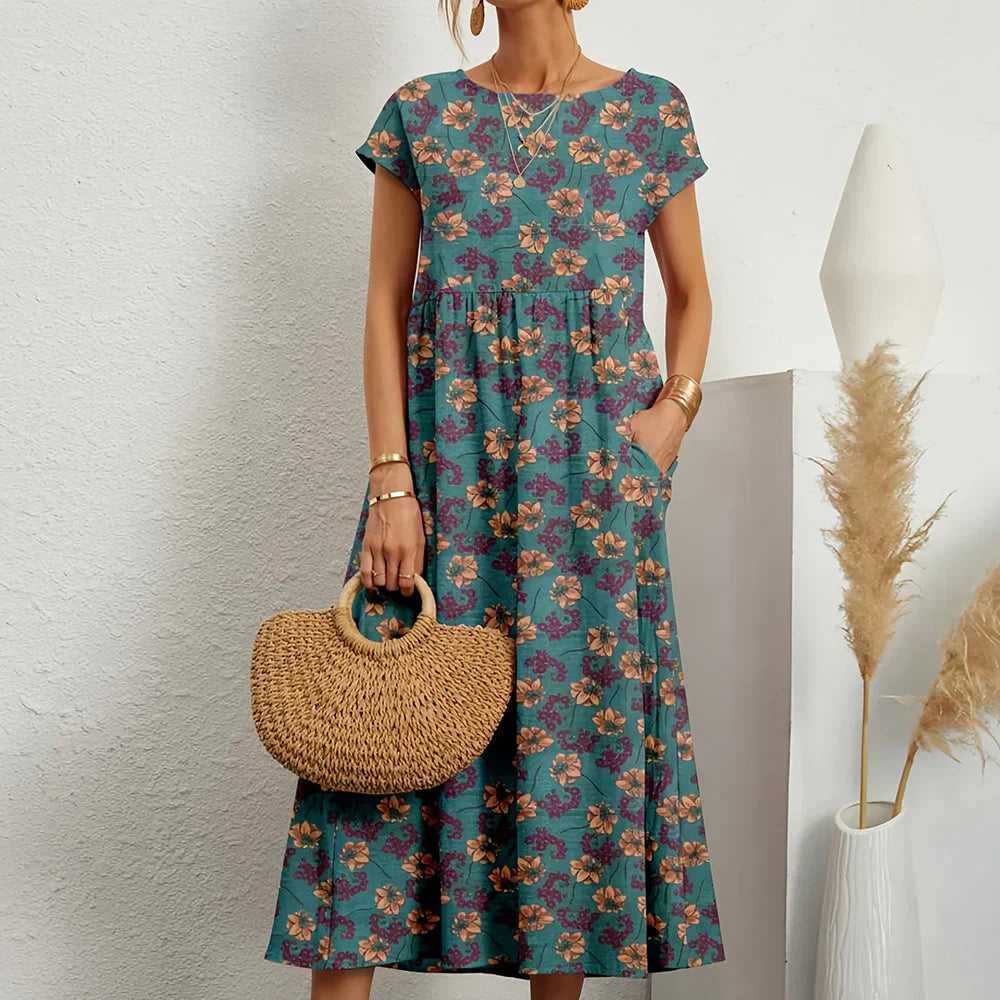 Versatile women's midi dress. Features round neck, cap sleeves, relaxed fit. Great casual spring/summer style.